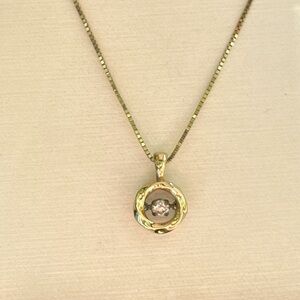 10k yellow gold Pulse necklace with a ‘floating’ diamond pendant.